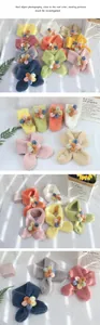 Close-up of colorful plush scarves with cute flower details for kids in various soft colors