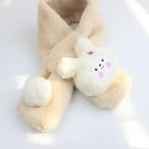 Close-up of fluffy beige children's plush scarf with cute bunny and soft pom pom