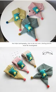 Detail of four colorful knitted children's scarves with cute cartoon dinosaur plush dolls
