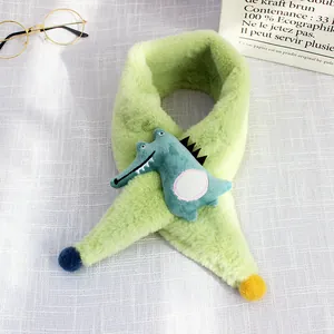 Detail of plush faux fur green kids scarf with cute 3D cartoon crocodile and pom-poms