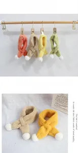 Detailed view of thick lamb velvet scarves for kids with cute plush pom-poms and cross buckle