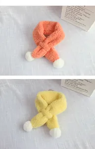 Detailed view of plush lamb velvet winter scarves with pom poms in orange and yellow
