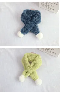 Detail of soft sherpa winter scarves in navy and lime with white pom-poms for kids