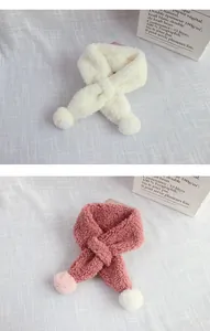 Detail view of winter lamb velvet scarves in cream and pink with soft pom-pom accents