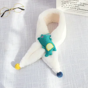 Detail of soft white plush kids scarf with 3D green cartoon crocodile and pom-poms