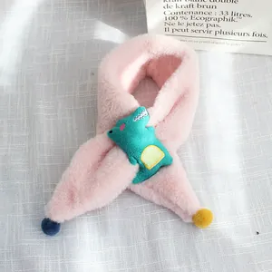 Detail of pink plush scarf for kids with green dinosaur patch and colorful pom-poms