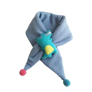 Blue knitted kids scarf featuring a cute plush crocodile and colorful pom-poms
