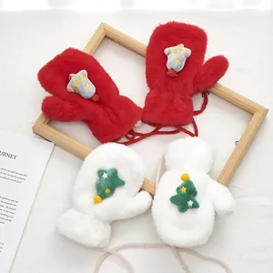 Detail of plush Christmas neck-hanging mittens for children with tree and bell patterns