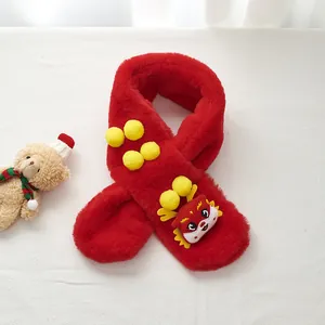 Detailed view of red plush child scarf with cartoon dragon patch and yellow pom-poms