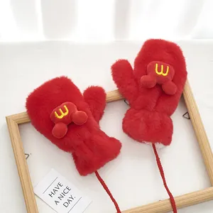 Detailed view of red plush mittens with a cute toy car and red anti-lost neck rope