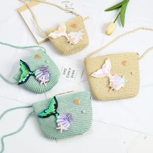 Detail of straw woven bags with sequin mermaid tail, seashell and pearl sea elements
