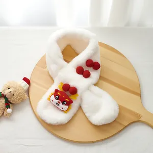 Detail of white plush scarf with red cartoon dragon embroidery and soft pom-poms