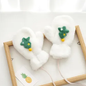 Detail of plush white mittens with green tree embroidery and soft faux rabbit fur texture