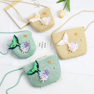 Detail of mermaid straw crossbody bags with sequins, starfish and pearl decorations