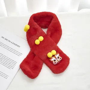 Detailed plush red scarf featuring traditional lion dance embroidery and soft yellow pom-poms