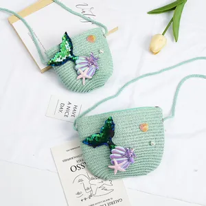 Detailed texture of mint green woven crossbody bag with mermaid sequins and seashell