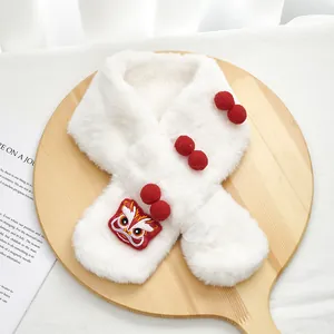 Detailed view of white plush scarf with lion dance embroidery and red pom-poms