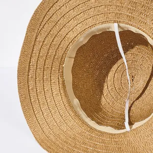 Close-up of inner woven straw hat detail with soft sweatband and elastic chin strap