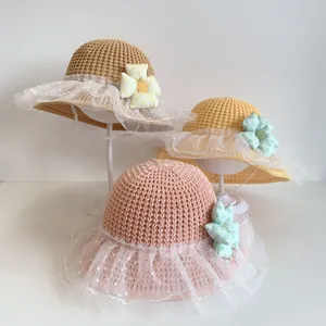 Kids woven straw sun hats with lace mesh trim and 3D floral accents in soft colors