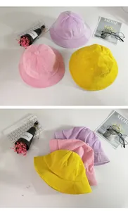 Detail view of corduroy bucket hats for kids in pink, purple, and yellow colors