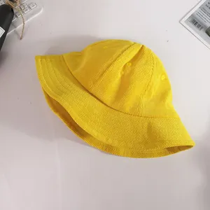 Vibrant yellow corduroy bucket hat for kids providing sun protection in an outdoor setting
