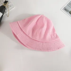 Close-up of pink corduroy bucket hat texture and material on a white background