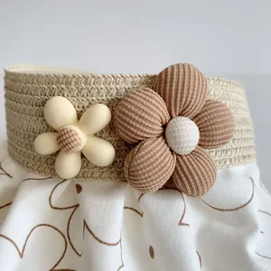 Close-up of decorative floral elements on woven straw sun visor with soft fabric