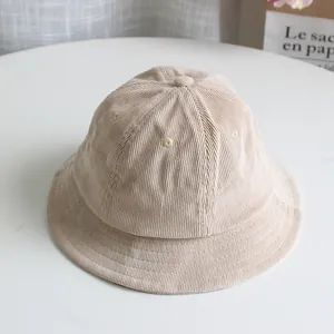 Close-up of beige corduroy kids bucket hat showing ribbed texture and fine stitching