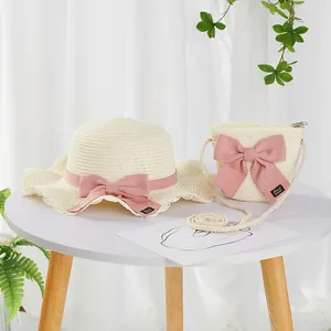 Detail of handmade bow on girls straw sun hat and matching crossbody bag set