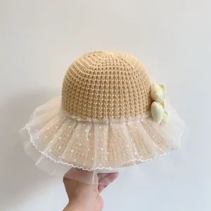 Detailed view of the woven straw material and white polka dot lace on children sun hat