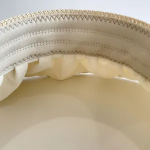 Close-up of beige woven children's sun hat featuring elastic sweatband and fine stitching