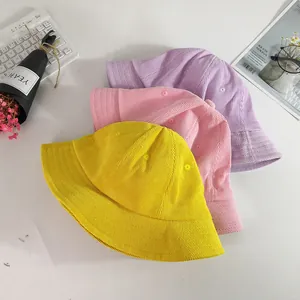 Three colorful corduroy bucket hats for kids in yellow, pink and purple for sun protection