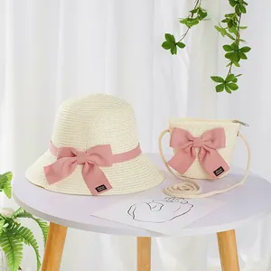 Kids straw hat and matching crossbody bag set with pink bows and handmade labels