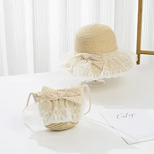 Close-up of girls straw sun hat with delicate lace floral trim and matching handbag