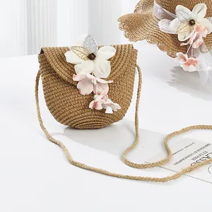 Straw woven girls purse with pink flowers for beach travel and summer vacation