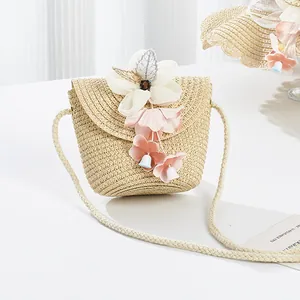 Detail of children's straw bag with 3D floral embroidery and fine shoulder strap