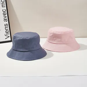 Pink and navy blue cotton bucket hats with wide brim for sun protection and outdoor travel