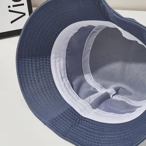 Detail of navy blue bucket hat featuring breathable white mesh lining and sweatband inside