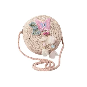 Cute round woven straw crossbody bag for girls with pink butterfly and floral tassel