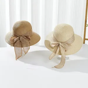Women's summer sun straw hat with wide wavy brim and large elegant mesh bow decoration