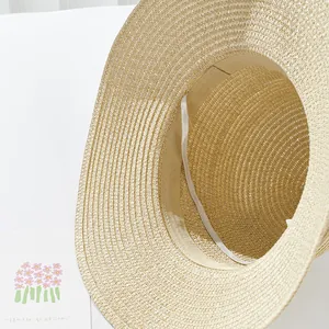 Detail of hand-woven straw hat interior showing moisture-wicking band and fine texture