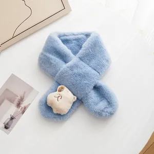 Close-up of light blue plush baby scarf featuring a cute cream cartoon bear decoration