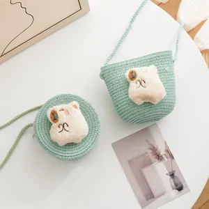 Mint green straw woven crossbody bags for kids featuring cute plush cat patches