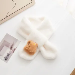 Detail of soft white plush scarf featuring a cute brown bear cartoon decorative element