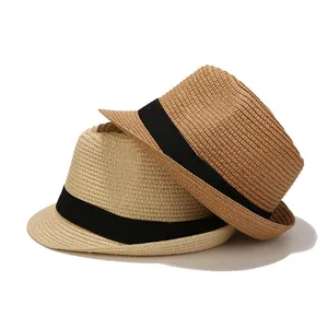 Close-up of finely woven straw sun hats with elegant black ribbon decoration