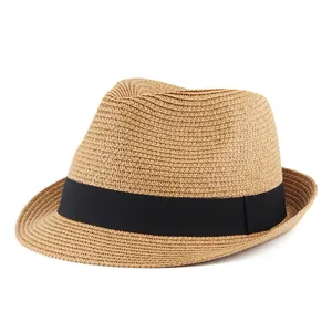 Detailed close-up of natural straw weave and black ribbon on a summer fedora hat
