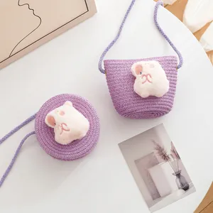 Detail of purple woven crossbody bags featuring cute plush rabbit patches and rope straps