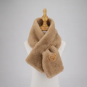 Close-up of camel faux rabbit fur scarf with cute 3D bear applique on white mannequin