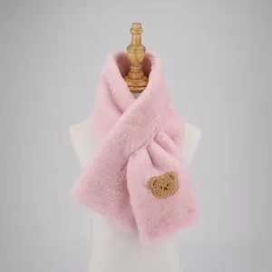 Close-up of pink faux rabbit fur scarf with a cute brown bear embroidery patch