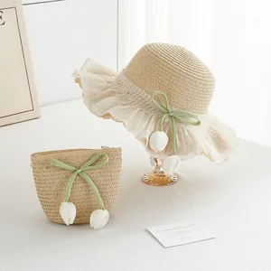 Detailansicht von beigem Strohhut und passender Mini-Tasche mit Spitze und Tulpenanhängern